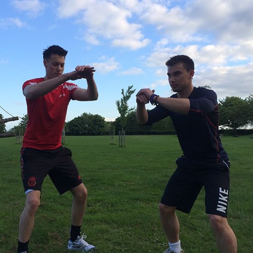 Ash Mills (left) and Stuart Lee (right) performing body-weight squats.