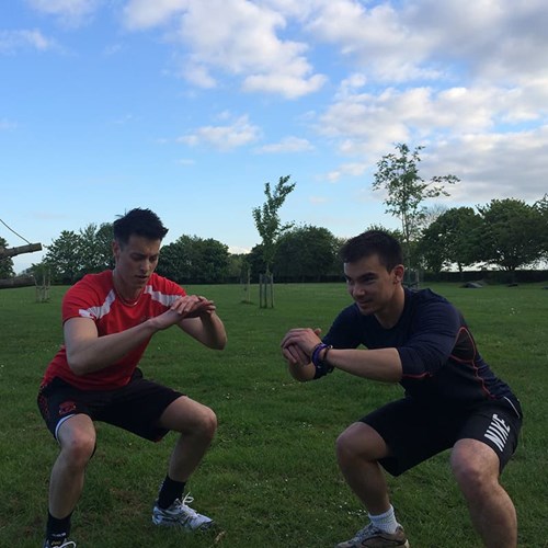 Ash Mills (left) and Stuart Lee (right) performing body-weight squats.